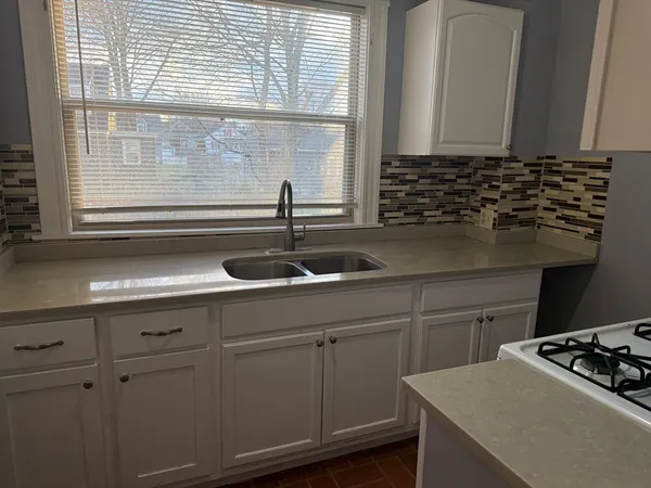 a kitchen with a sink and cabinets