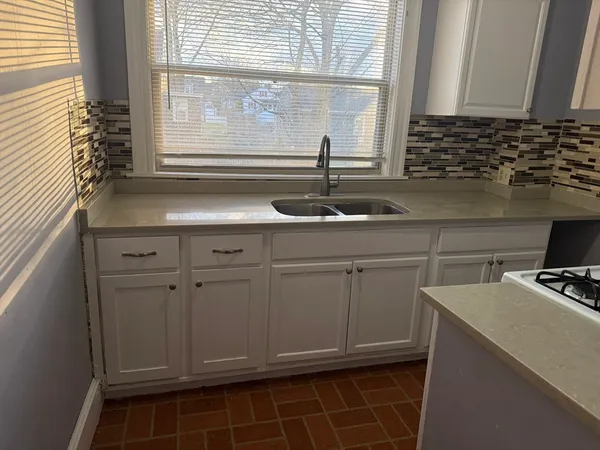a kitchen with a sink and cabinets