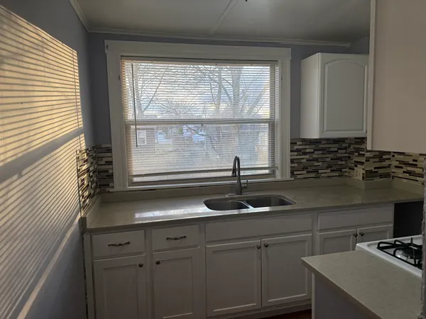 a kitchen with a sink and a window