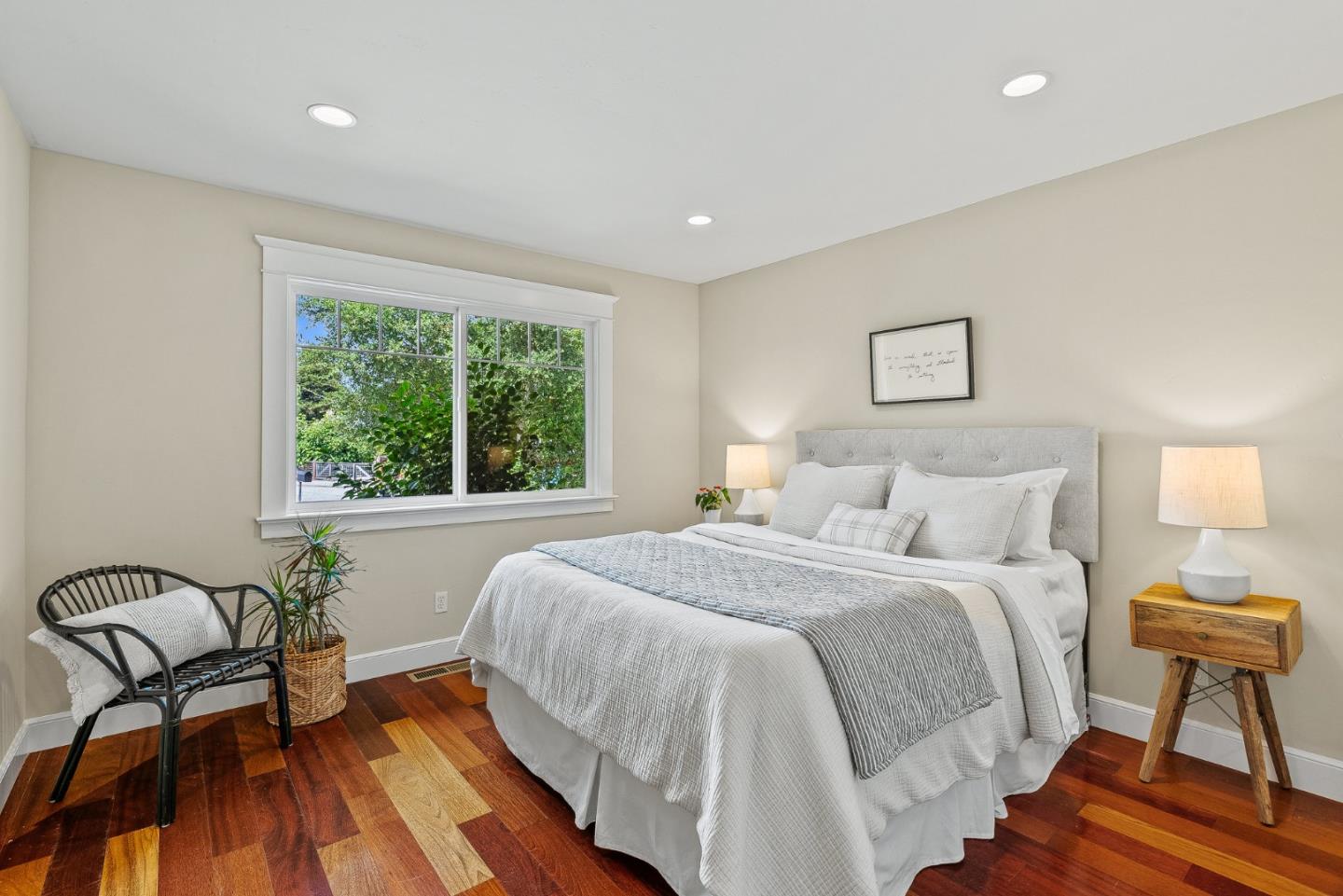 555 Risso Court Santa Cruz, CA 95062 - Photo 25 of 61 a spacious bedroom with a bed a couch and a potted plant on dresser
