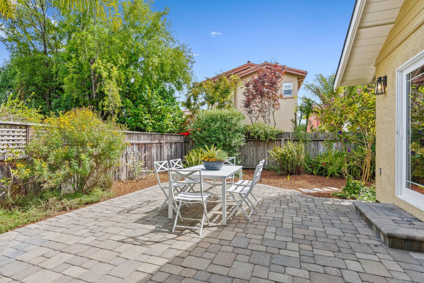 555 Risso Court Santa Cruz, CA 95062 - Photo 46 of 61 a view of a patio with a table and chairs under an umbrella
