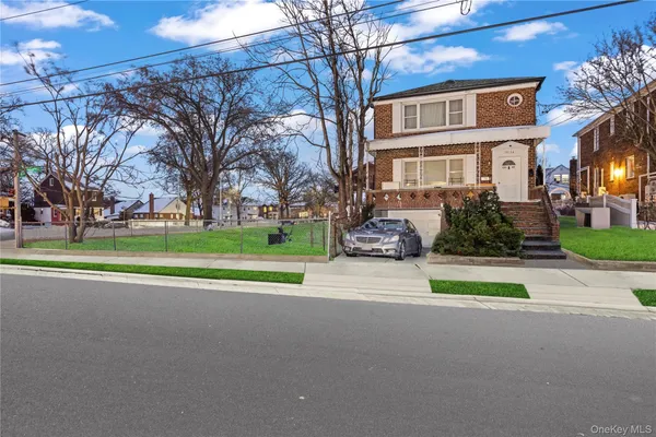 a front view of house with yard and green space