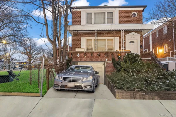 a car parked in front of a white house