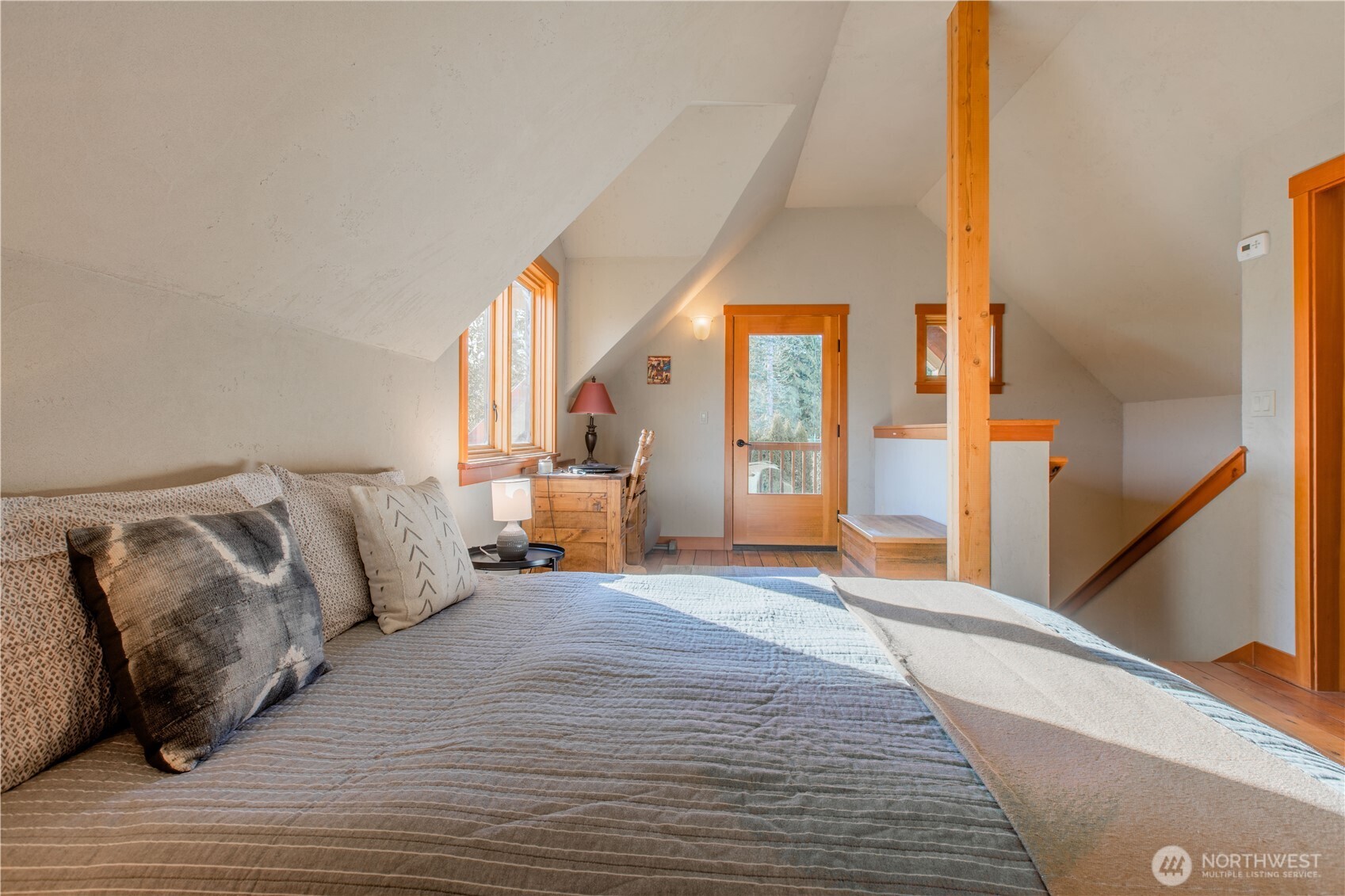2516 Mill Avenue Bellingham, WA 98225 - Photo 11 of 36 a view of a bedroom with a large bed and wooden floor