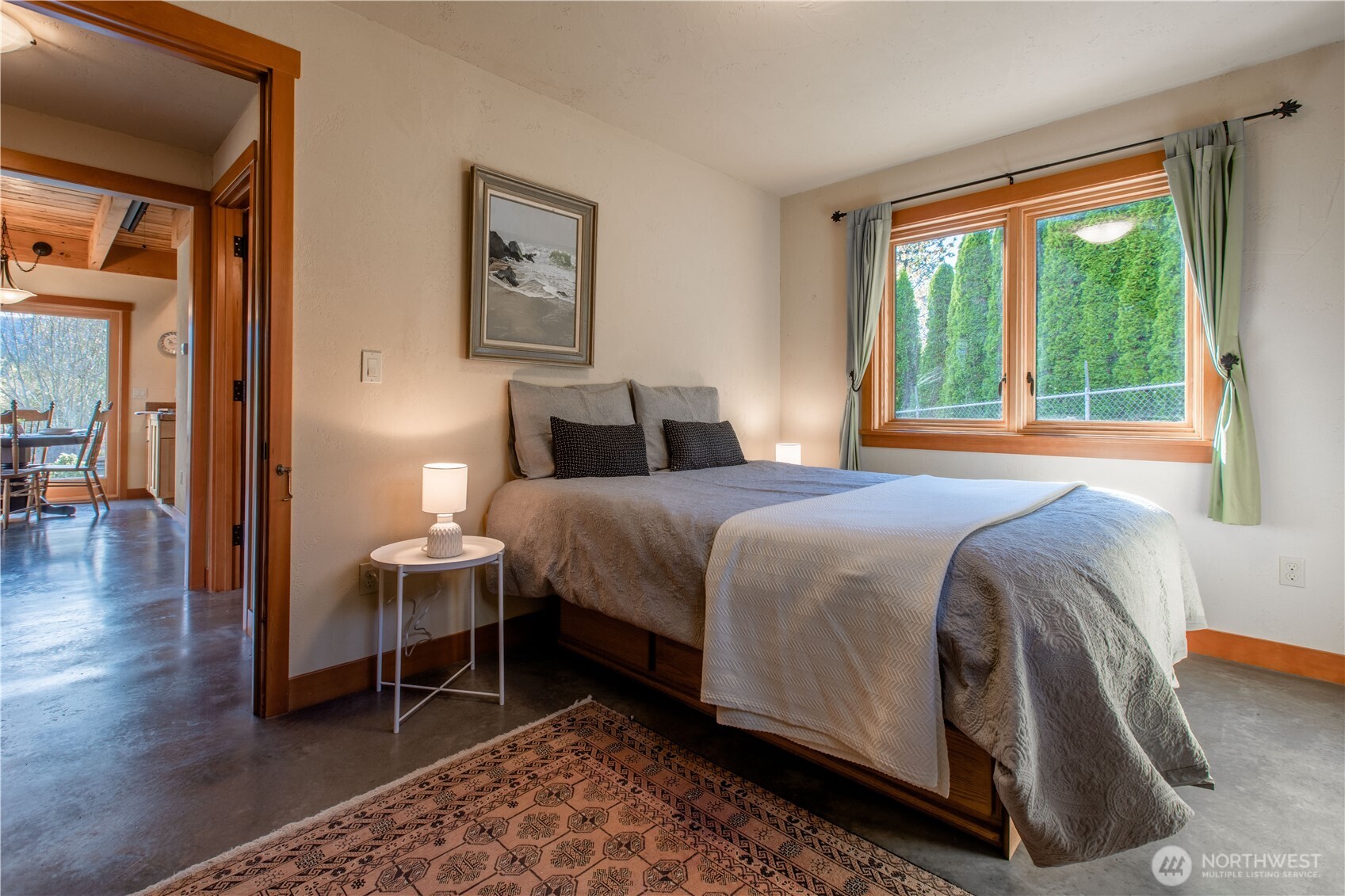 2516 Mill Avenue Bellingham, WA 98225 - Photo 16 of 36 a bedroom with a bed and a lamp next to a window