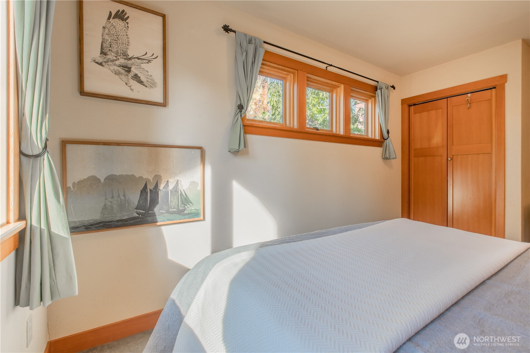 2516 Mill Avenue Bellingham, WA 98225 - Photo 18 of 36 a bedroom with a bed and a painting on the wall