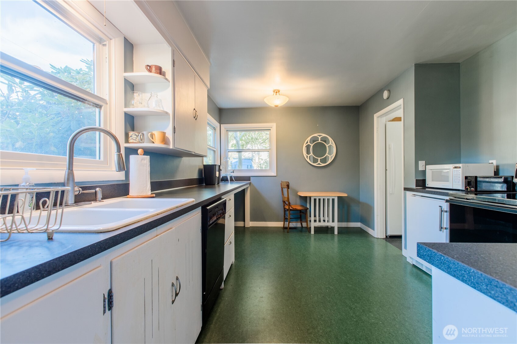 2516 Mill Avenue Bellingham, WA 98225 - Photo 30 of 36 a open kitchen with stainless steel appliances granite countertop a sink a stove and a refrigerator