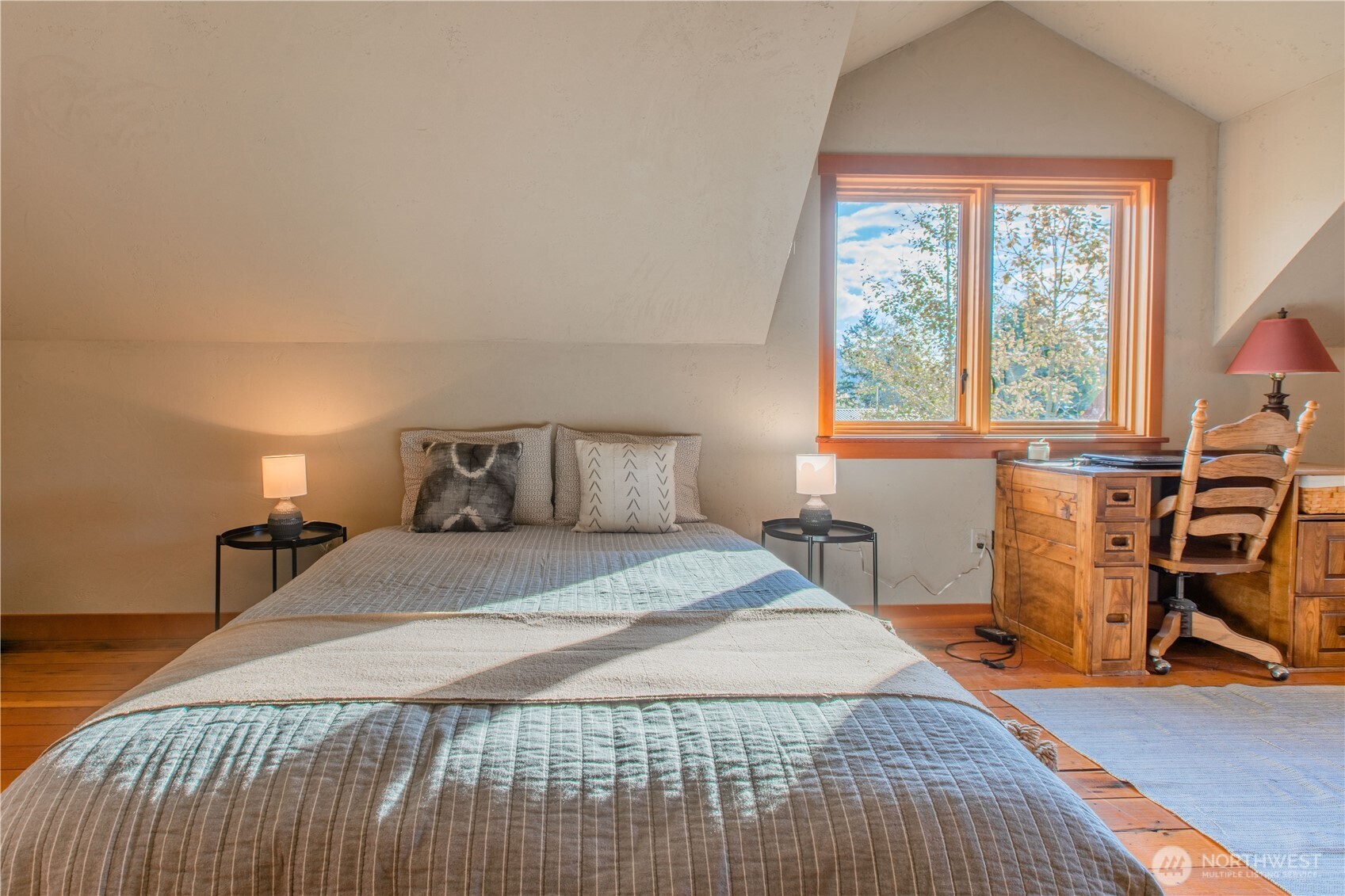 2516 Mill Avenue Bellingham, WA 98225 - Photo 10 of 36 a bedroom with a bed and wooden floor