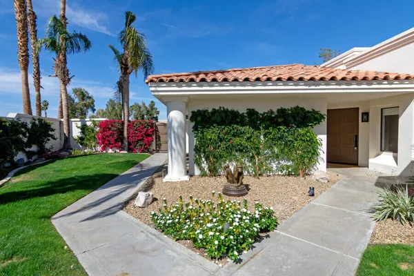 a view of a house with garden and plants