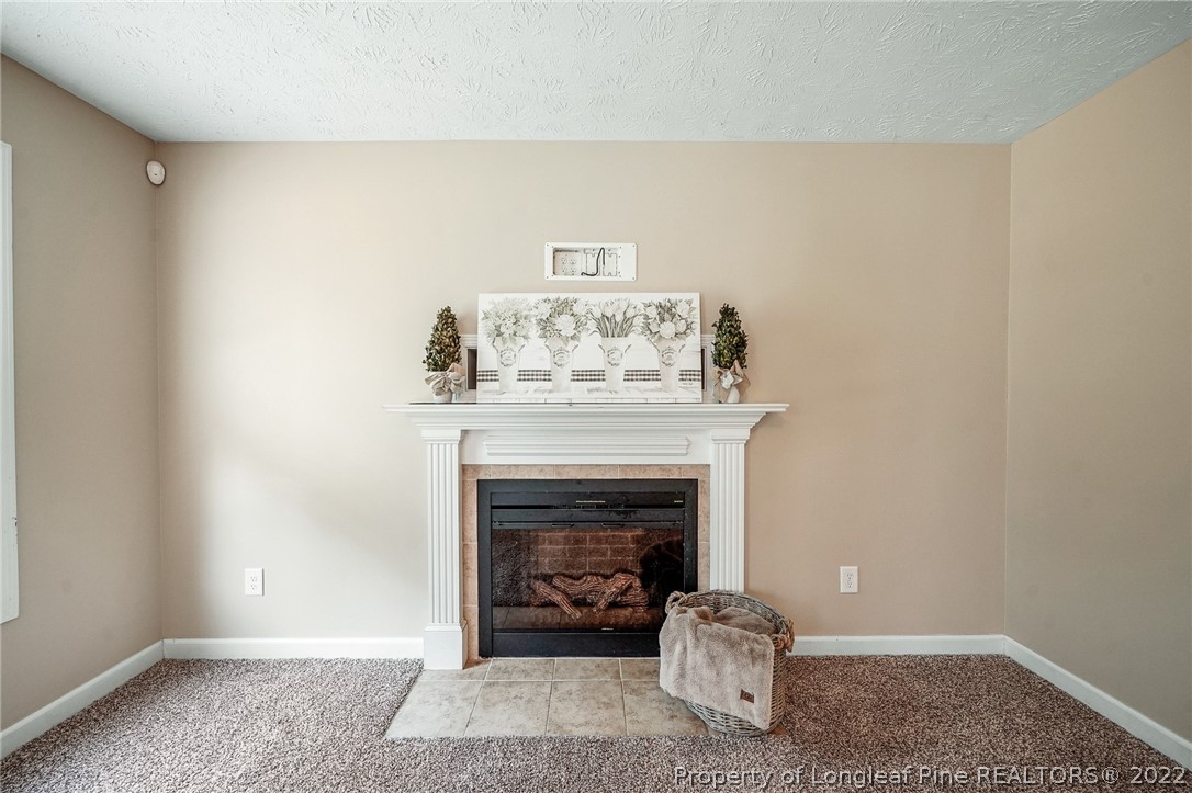 2673 Rockfish Road Raeford, NC 28376 - Photo 13 of 42 a living room with furniture and a fireplace