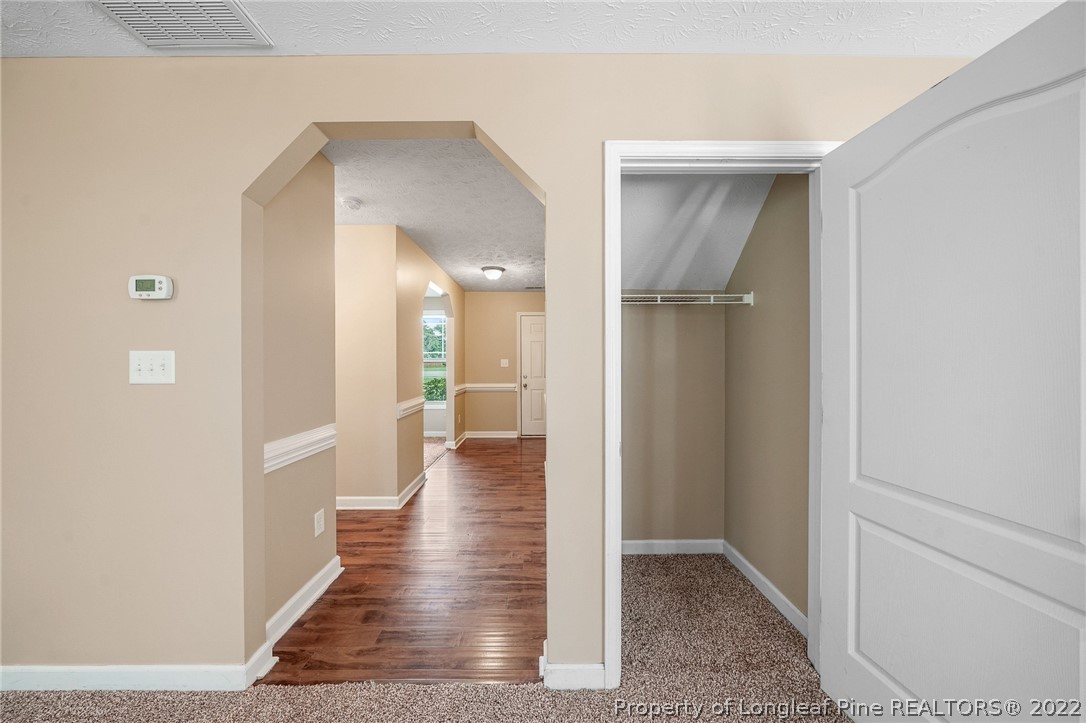 2673 Rockfish Road Raeford, NC 28376 - Photo 19 of 42 a view of a hallway with wooden floor