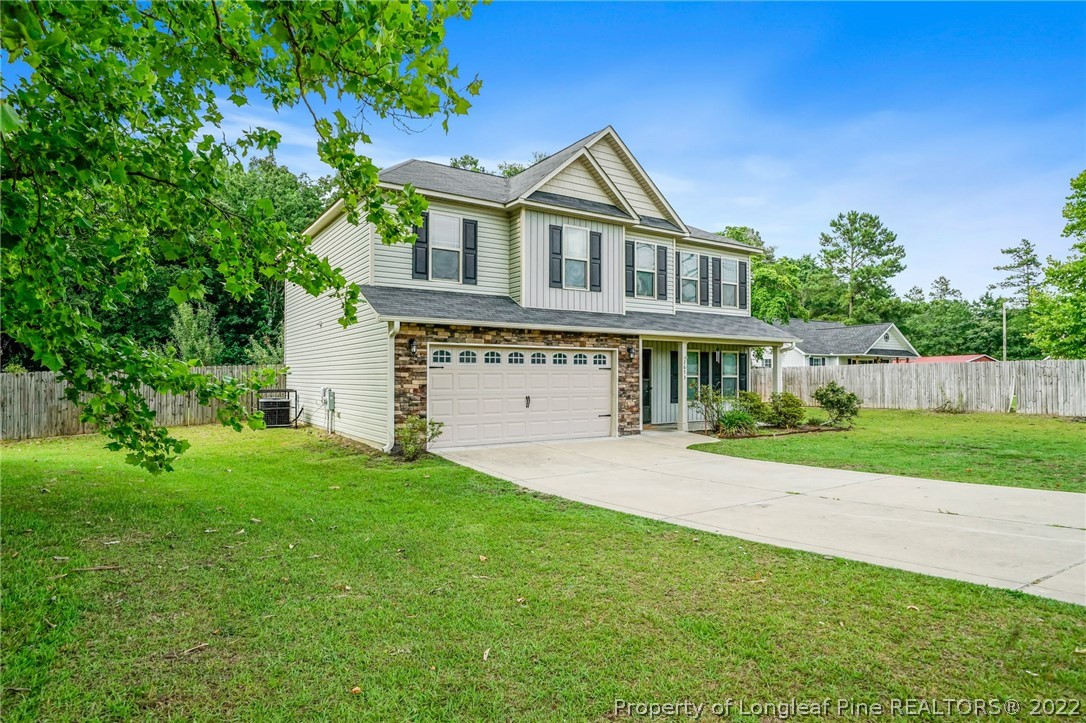 2673 Rockfish Road Raeford, NC 28376 - Photo 2 of 42 a front view of a house with a yard and trees