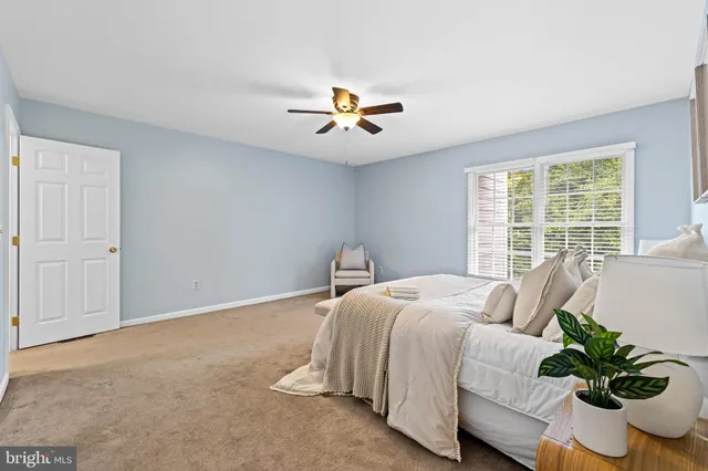 a bedroom with bed and a potted plant