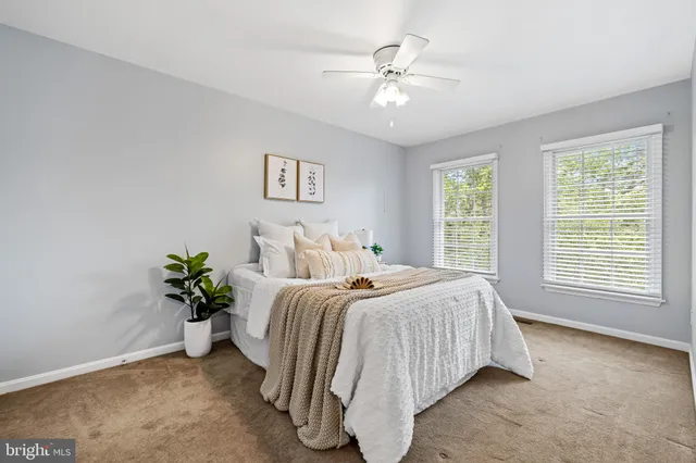 a bedroom with bed and a chandelier