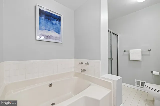 a white bath tub sitting next to a white toilet