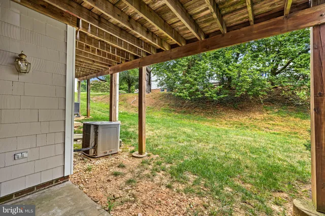 a view of a porch with a table and chairs in patio