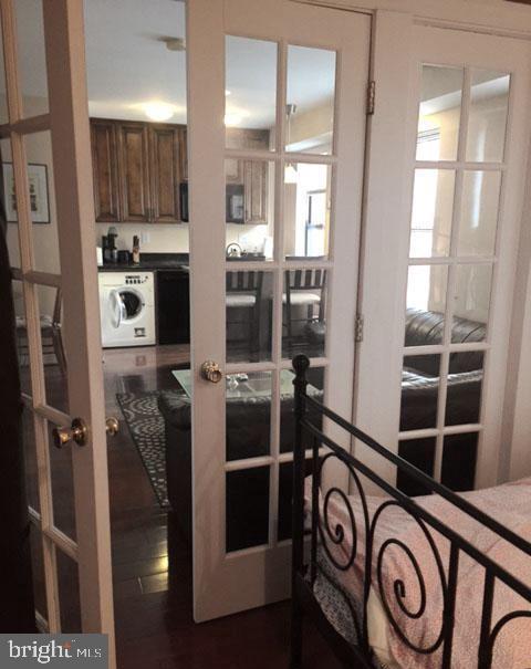1125 12th Street Northwest, Unit 64 Washington, DC 20005 - Photo 16 of 42 a view of washer and dryer with kitchen in the background