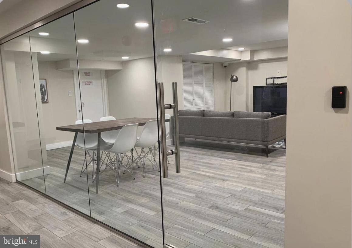1125 12th Street Northwest, Unit 64 Washington, DC 20005 - Photo 28 of 42 a living room with furniture and a chandelier