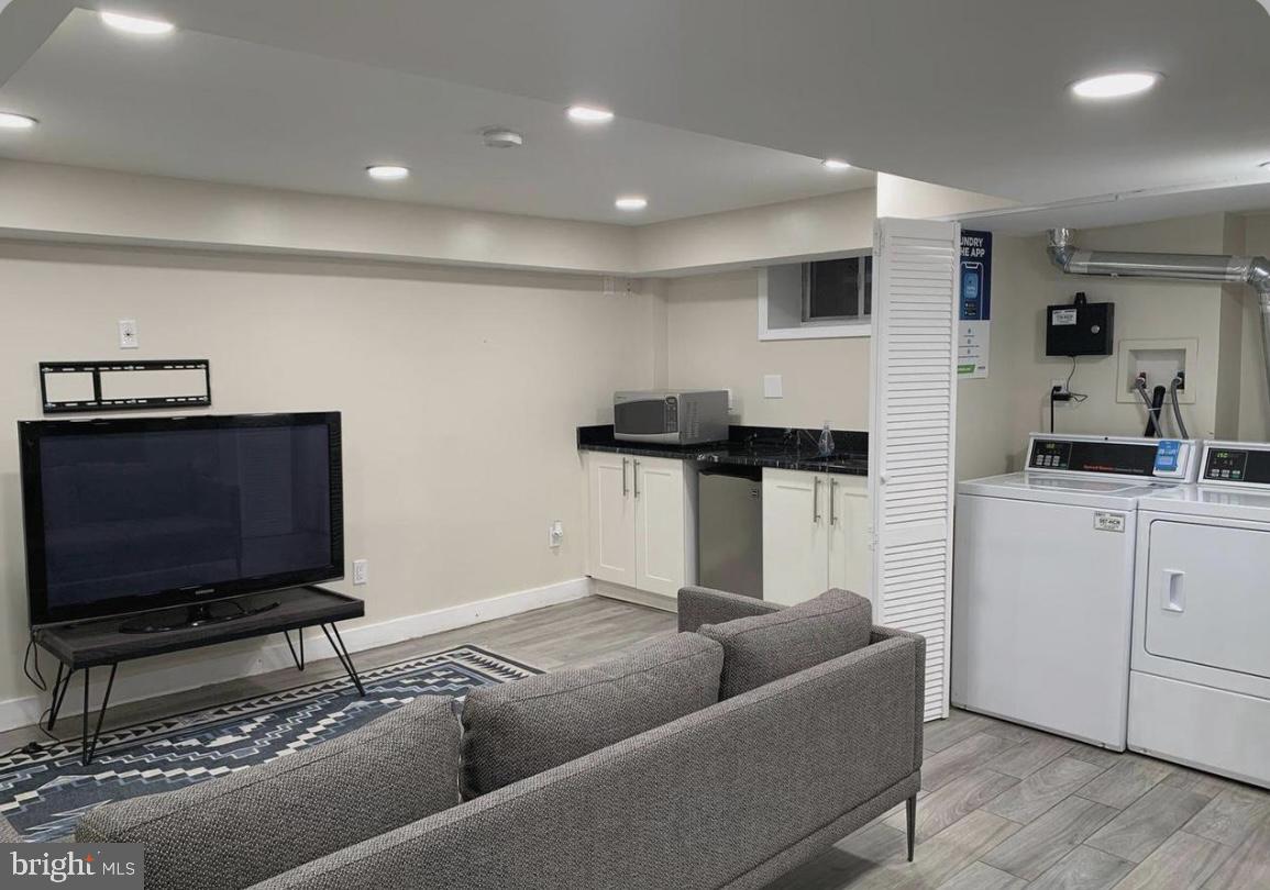 1125 12th Street Northwest, Unit 64 Washington, DC 20005 - Photo 29 of 42 a living room with furniture and a flat screen tv