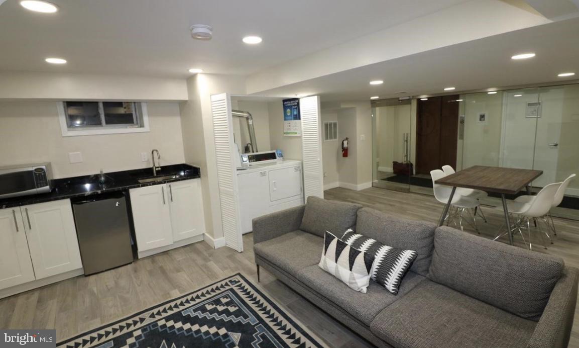 1125 12th Street Northwest, Unit 64 Washington, DC 20005 - Photo 31 of 42 a living room with furniture and a rug