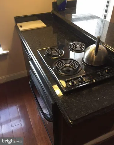 a stove top oven sitting inside of a kitchen