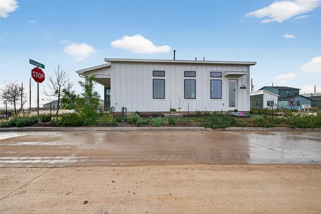 a front view of a house with a yard and a garage