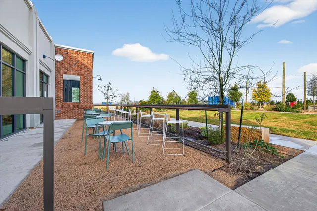 a view of a patio with a table and chairs