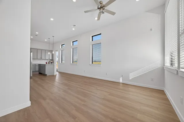 a view of a kitchen with furniture and wooden floor