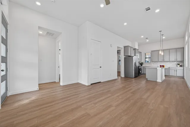 a view of a electric appliances in center and wooden floor