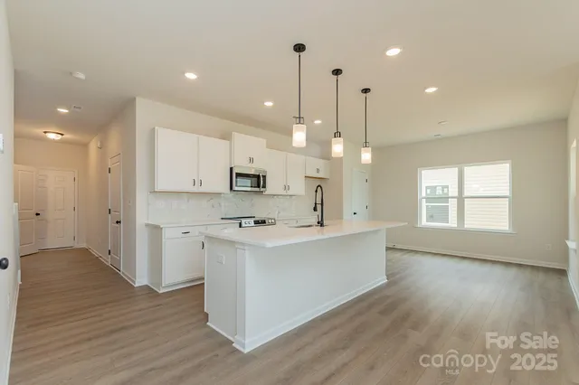 a view of a kitchen counter top space and stainless steel appliances