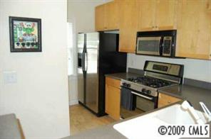 3444 Stettler View Road, Unit 225 Charlotte, NC 28210 - Photo 2 of 8 a kitchen with stainless steel appliances a stove a microwave and a refrigerator