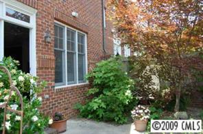 3444 Stettler View Road, Unit 225 Charlotte, NC 28210 - Photo 7 of 8 a view of a brick house with a flower garden