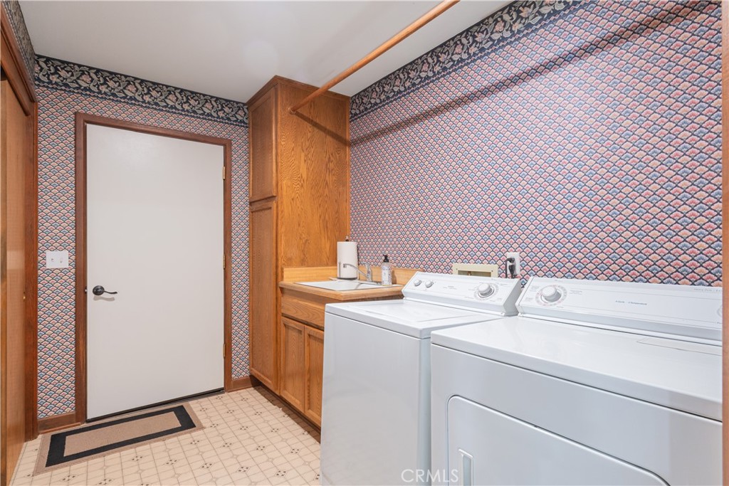 2085 Hanging Tree Lane Templeton, CA 93465 - Photo 20 of 33 Laundry room with storage cabinets, hanging rack and a convenient wash sink. There is also an entry door to the 3 car garage.