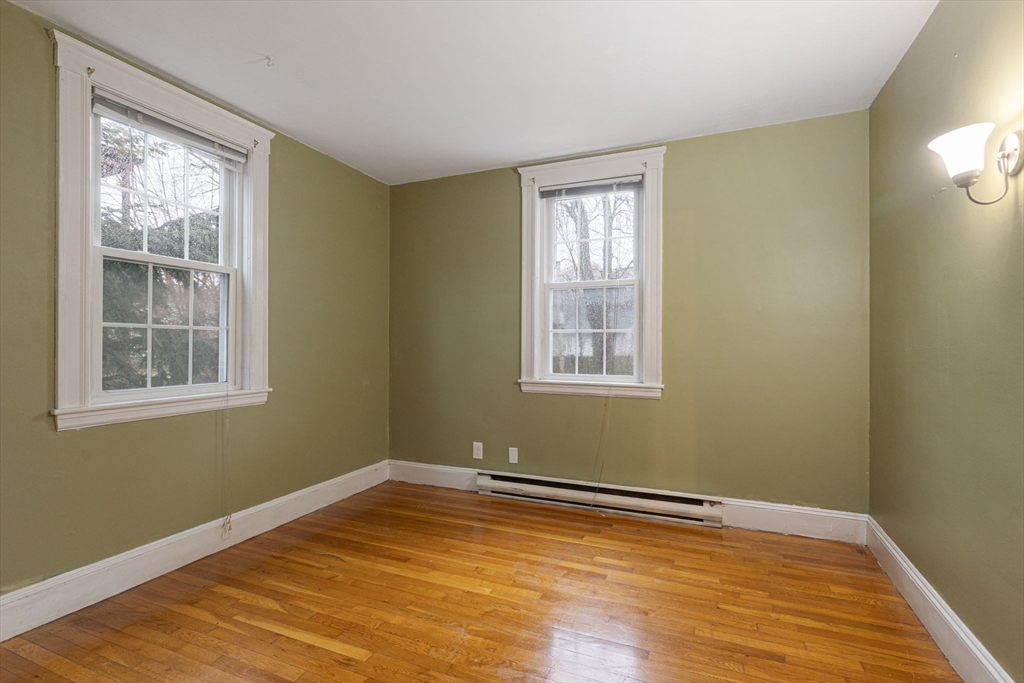 161 Florence Street, Unit 2 Boston, MA 02131 - Photo 11 of 14 a view of a room with wooden floor and windows