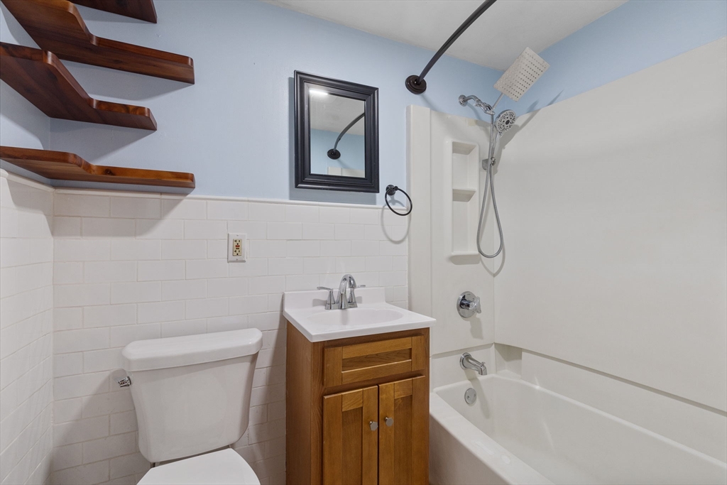 161 Florence Street, Unit 2 Boston, MA 02131 - Photo 12 of 14 a bathroom with a sink toilet and shower