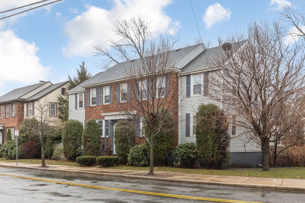 161 Florence Street, Unit 2 Boston, MA 02131 - Photo 2 of 14 a front view of a house with a yard