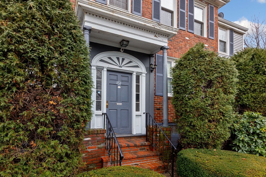 161 Florence Street, Unit 2 Boston, MA 02131 - Photo 3 of 14 front view of a house with a small yard