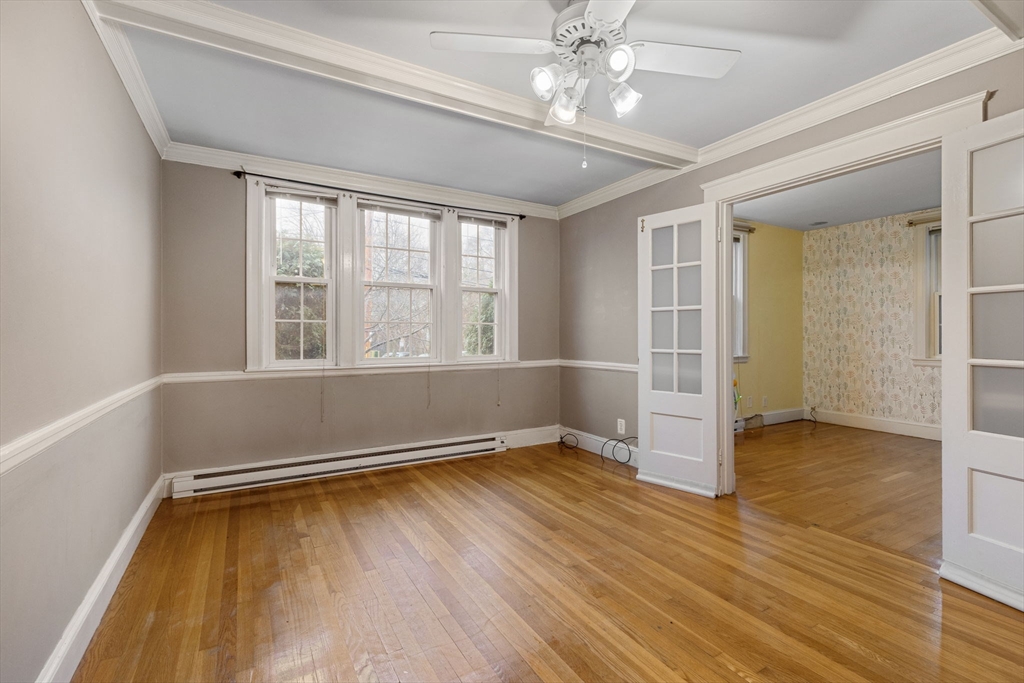 161 Florence Street, Unit 2 Boston, MA 02131 - Photo 4 of 14 wooden floor in an empty room with a window