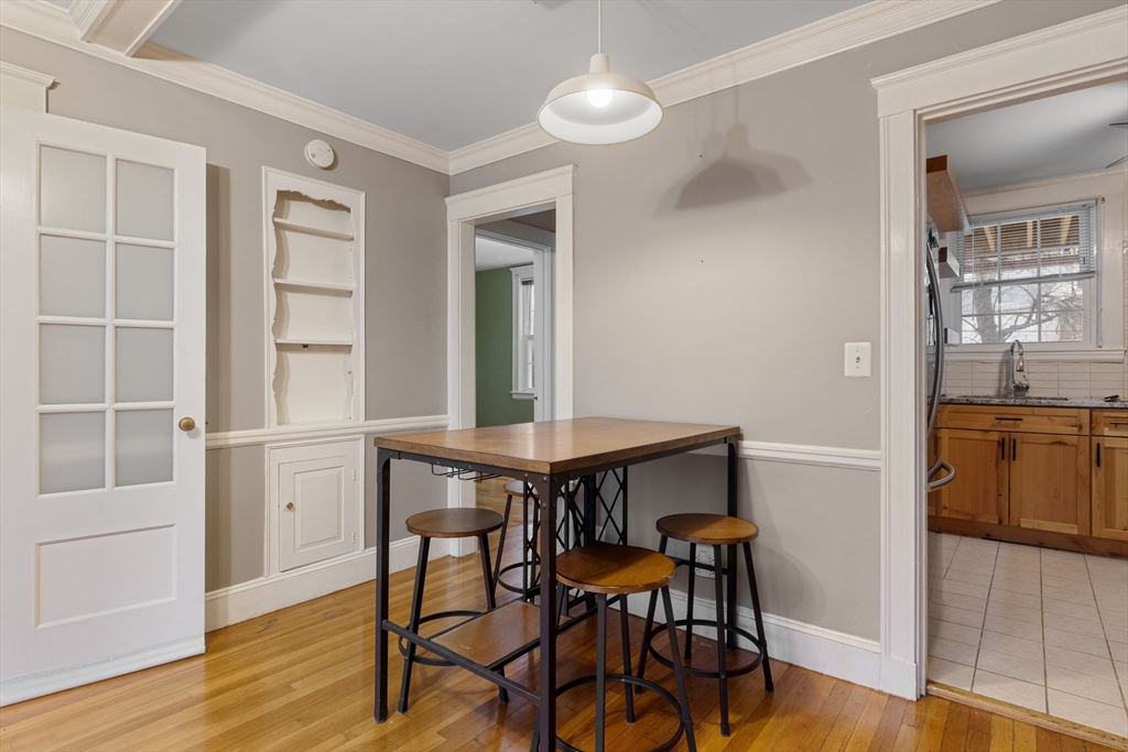 161 Florence Street, Unit 2 Boston, MA 02131 - Photo 6 of 14 a view of a dining room with furniture and wooden floor