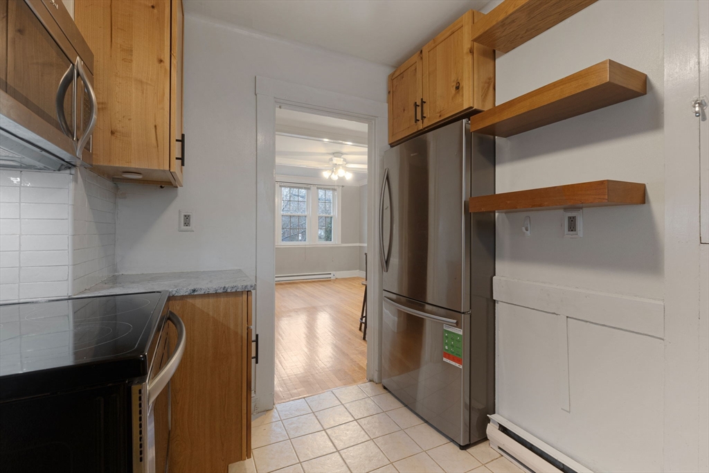 161 Florence Street, Unit 2 Boston, MA 02131 - Photo 8 of 14 a kitchen with a refrigerator and microwave