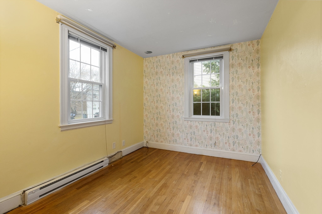 161 Florence Street, Unit 2 Boston, MA 02131 - Photo 9 of 14 a view of a room with wooden floor and windows