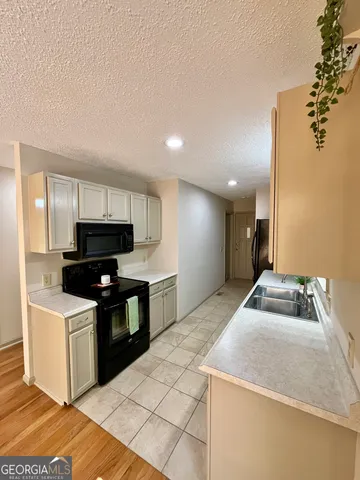 a kitchen with stainless steel appliances kitchen island granite countertop a sink and a stove