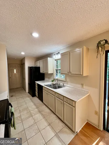a large kitchen with a sink and cabinets