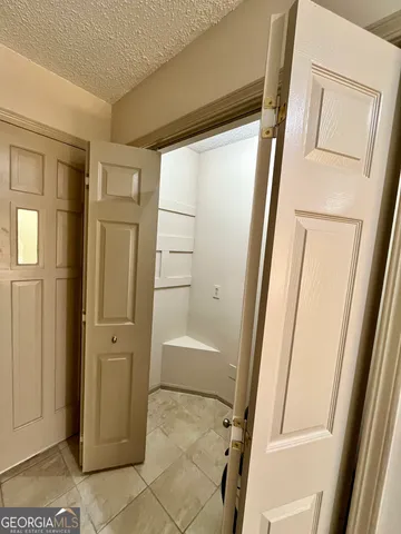 a bathroom with a tub and a glass door