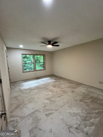 an empty room with a empty space and windows