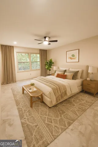 a spacious bedroom with a large bed and a chandelier