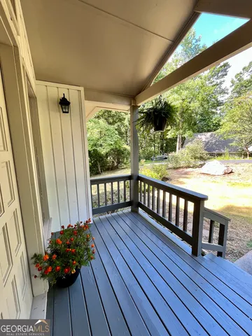 a view of a porch with wooden floor