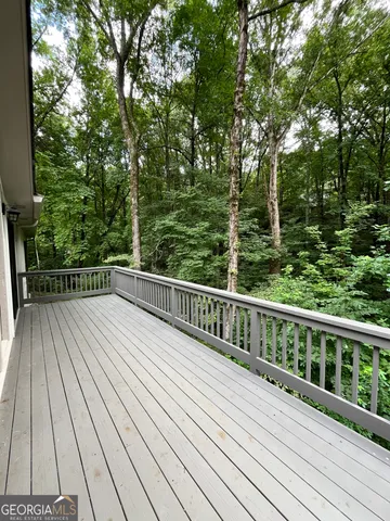 a view of balcony with wooden floor and fence
