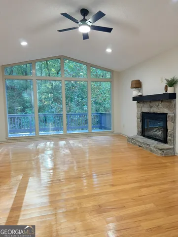 a view of an empty room with a fireplace and a window