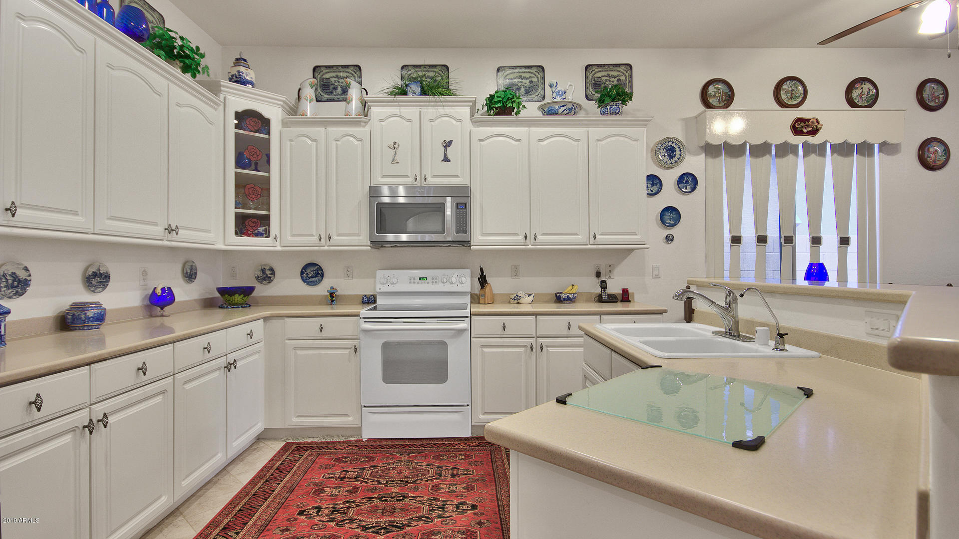 5522 West Carson Road Laveen, AZ 85339 - Photo 8 of 32 a kitchen with cabinets appliances and a sink